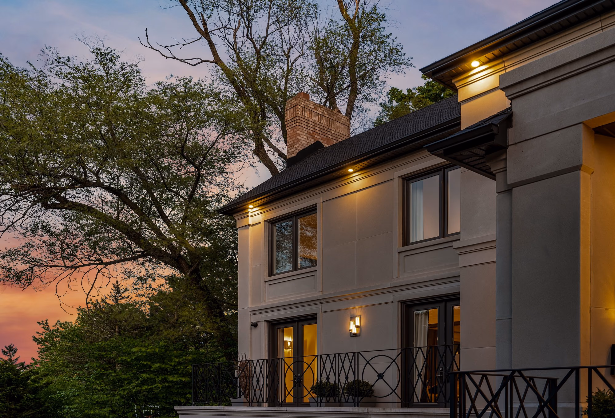 Stone home exterior against a dramatic dusk sky