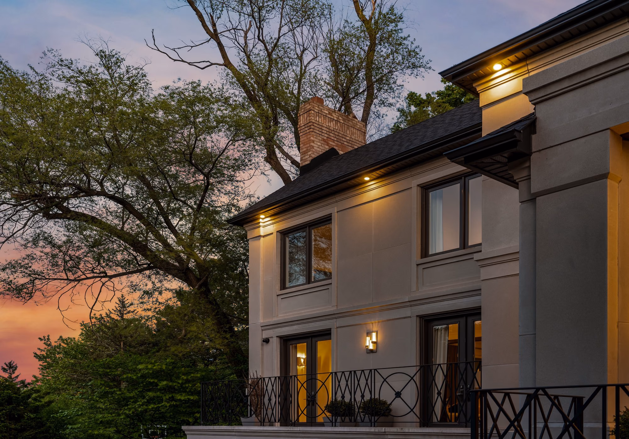 Stone home exterior against a dramatic dusk sky