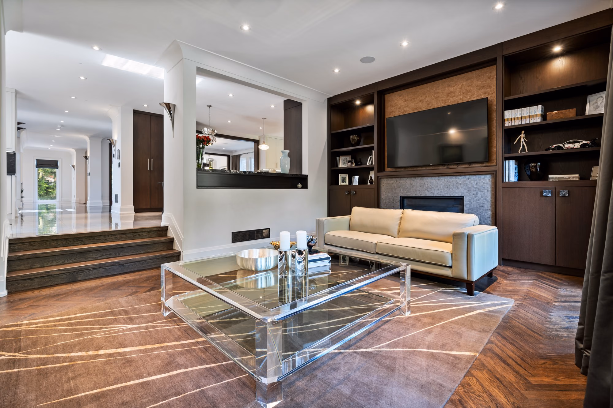 Family room with built-in media wall and acrylic coffee table