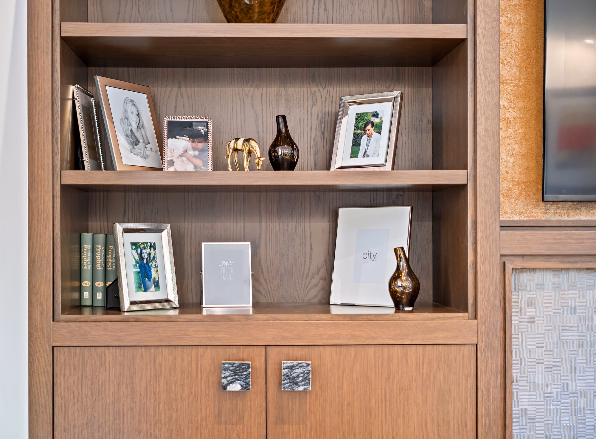 Built-in wood shelving styled with frames and objects