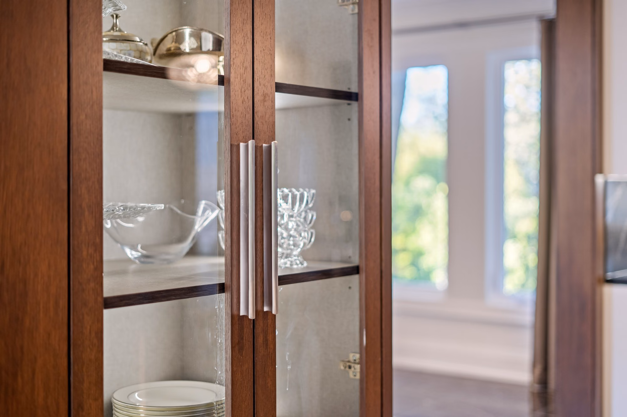 Glass cabinet doors with crystal glassware detail