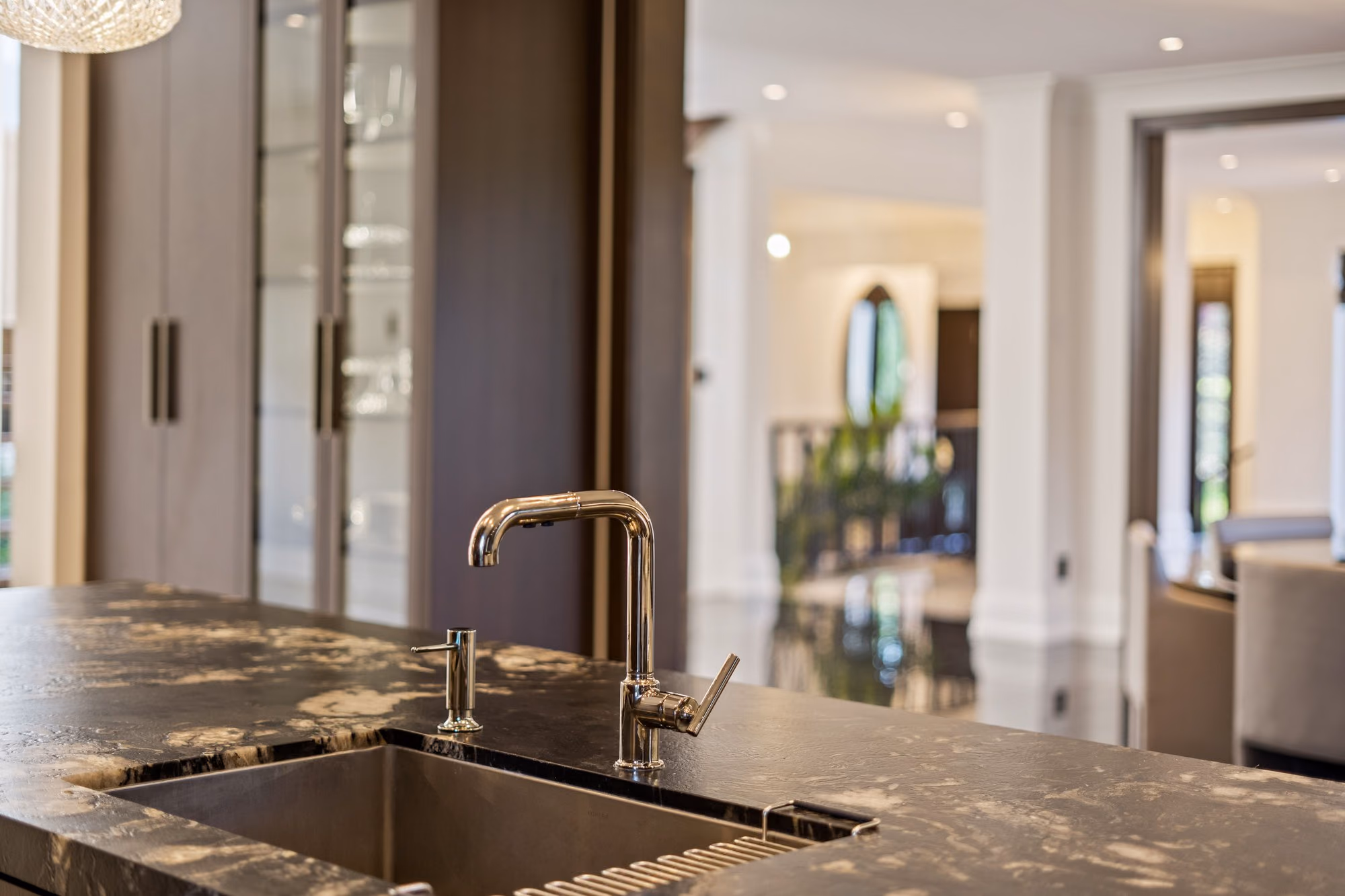 Island sink with polished faucet on granite counter