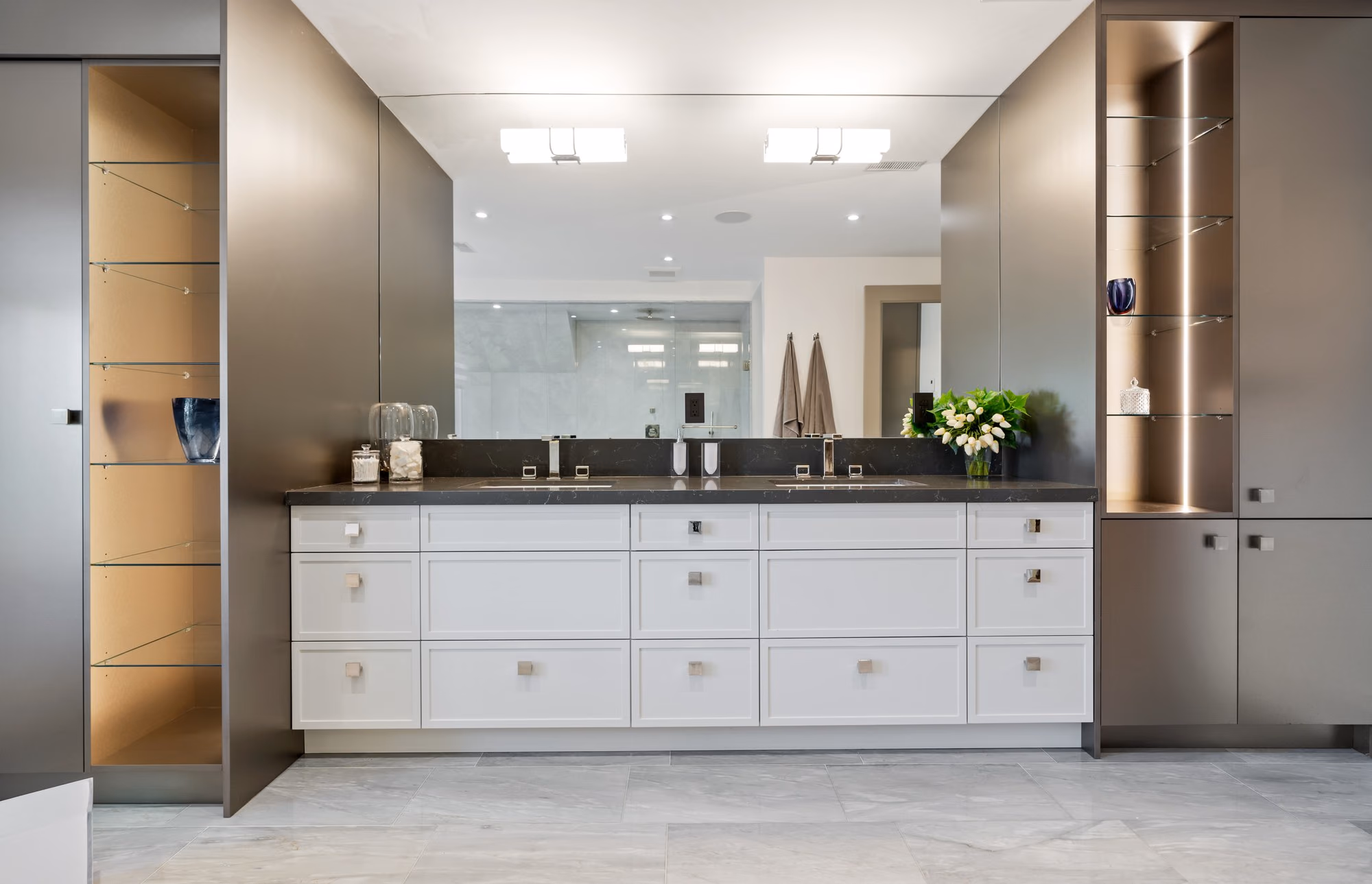 Long floating vanity with backlit mirror in the dressing suite