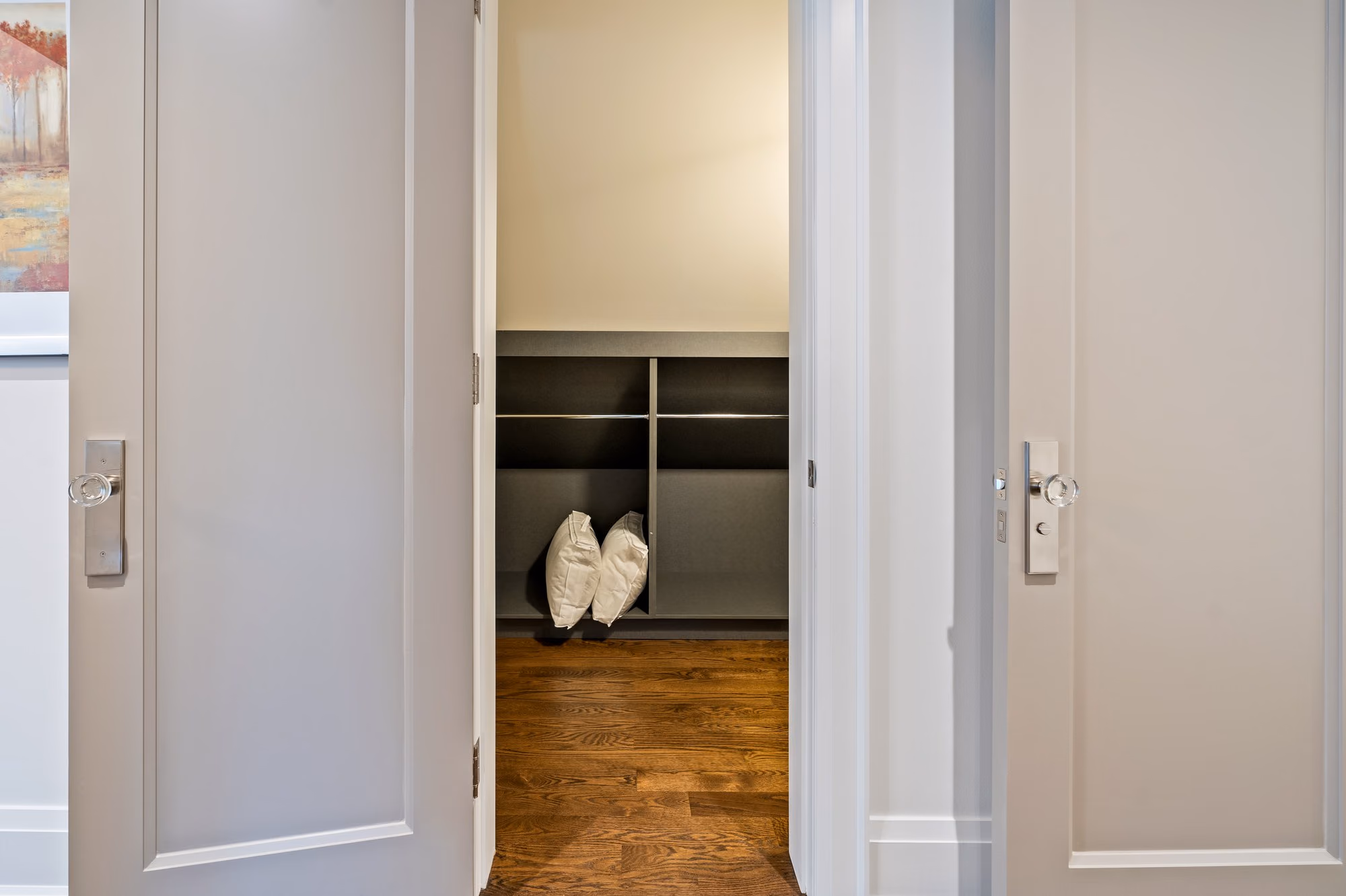 Closet corridor with white built-in wardrobes