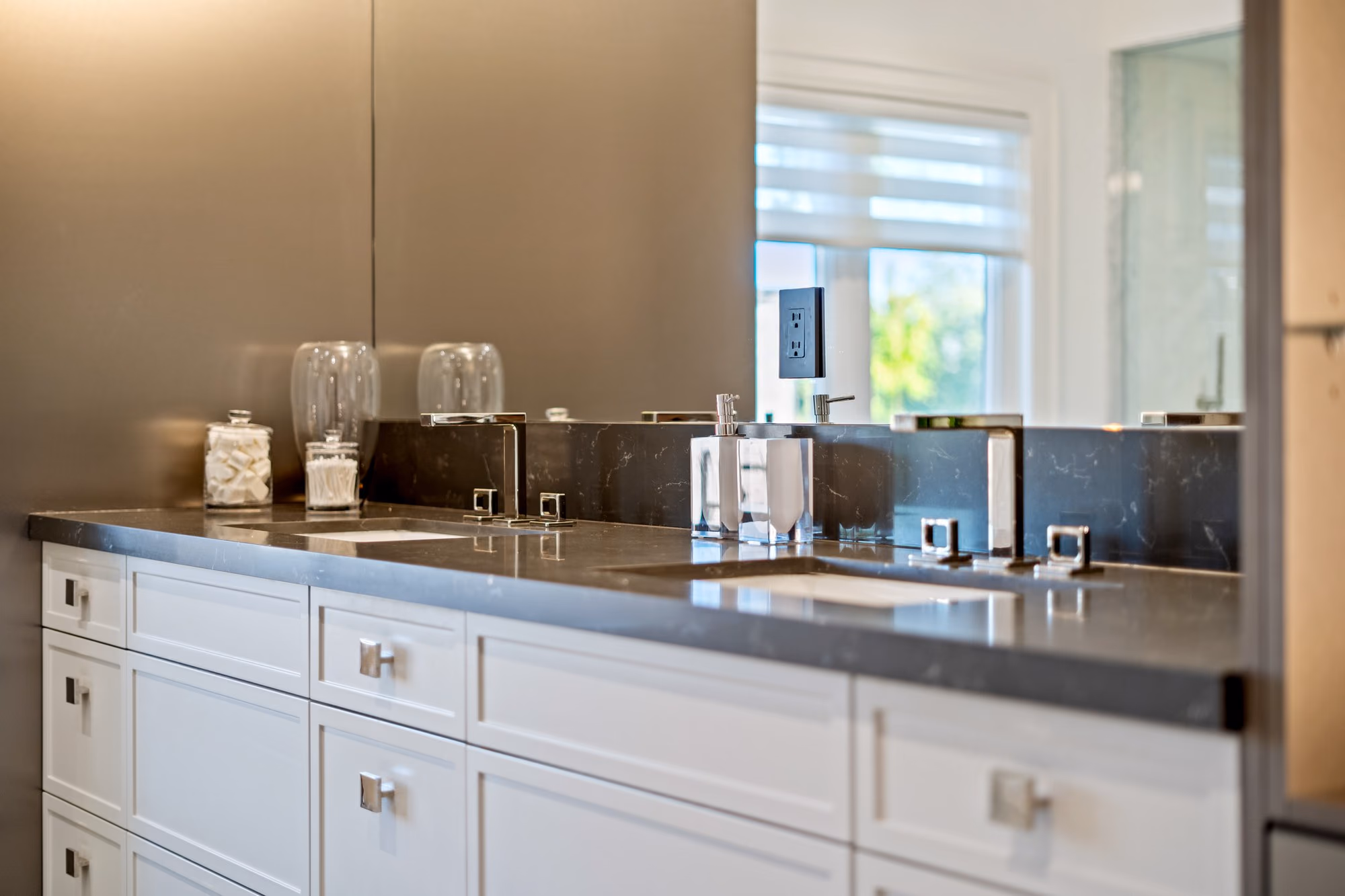 White kitchen cabinetry with dark counters