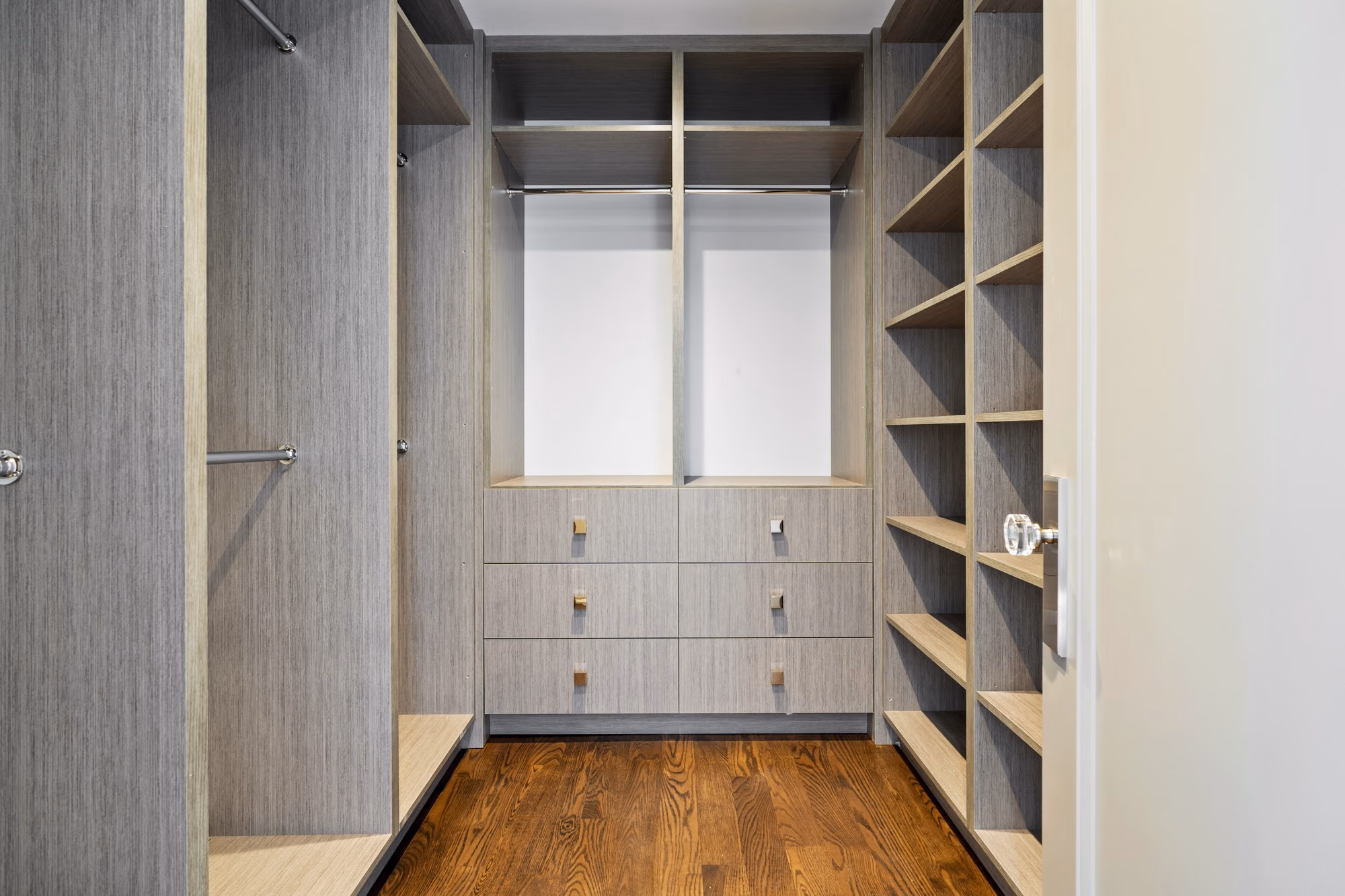 Walk-in closet with built-in shelving and drawers