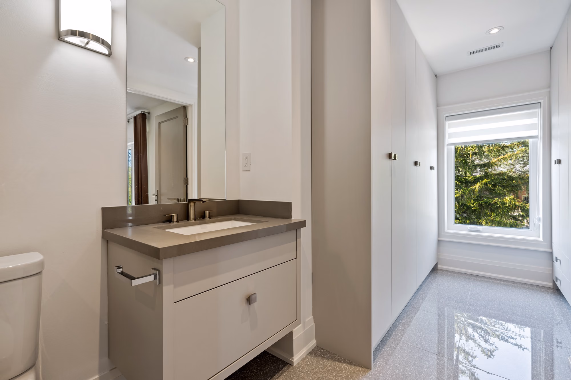 Bathroom vanity with toilet and window light