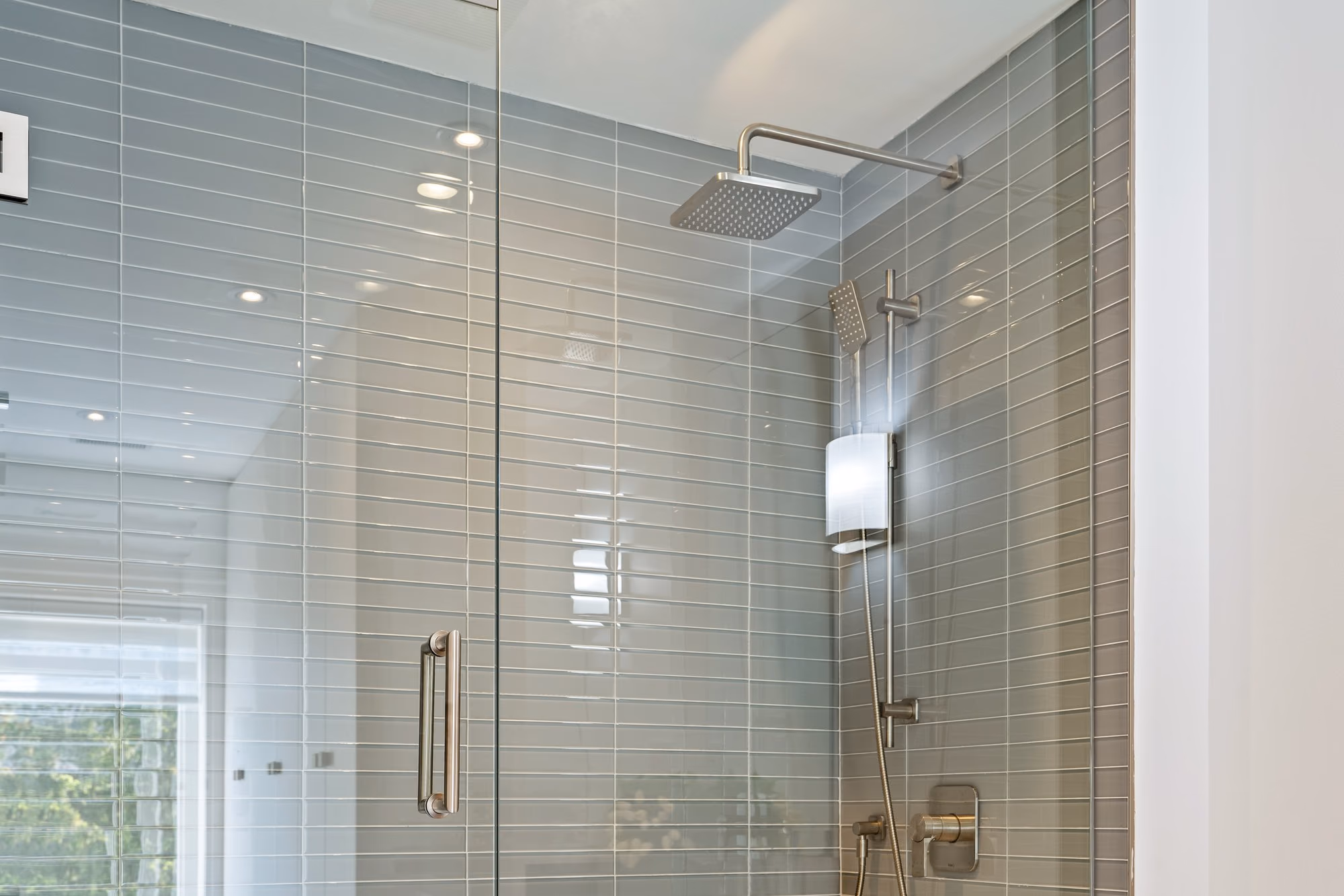Glass shower with rainfall head and tiled wall