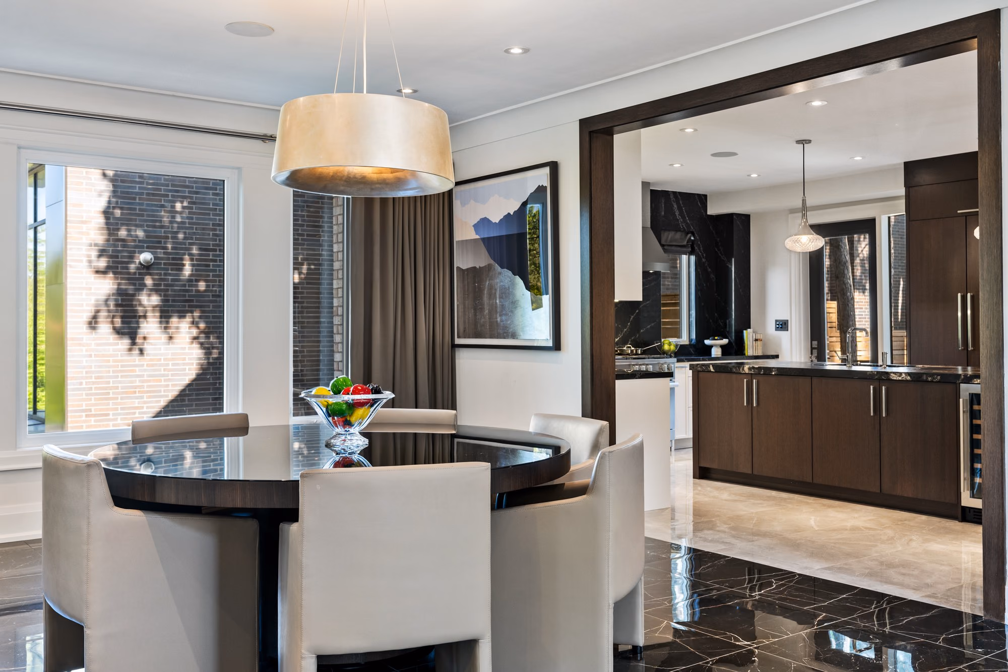 Kitchen with round dining table and dark marble accents