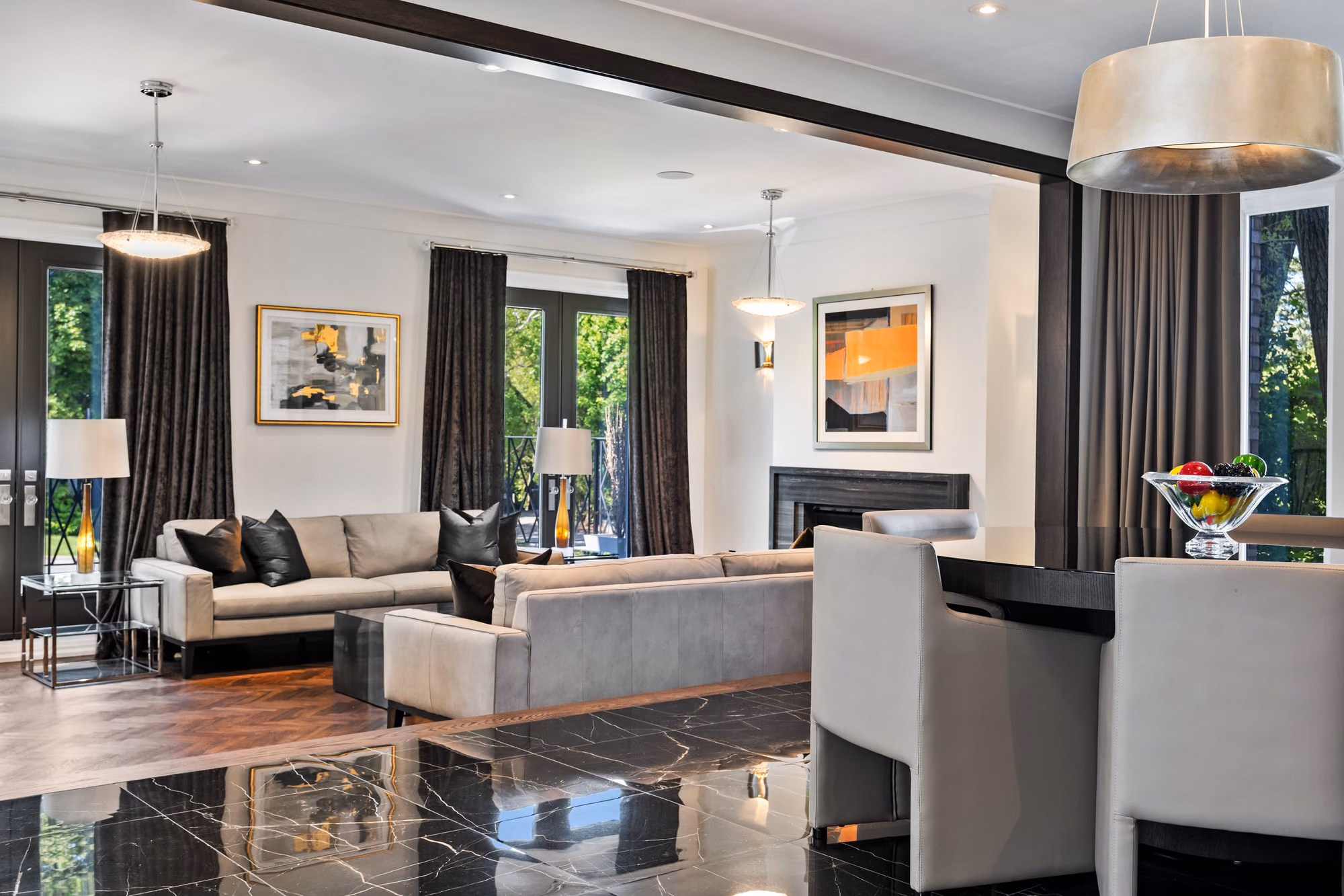 Formal living room with black marble floor and layered seating