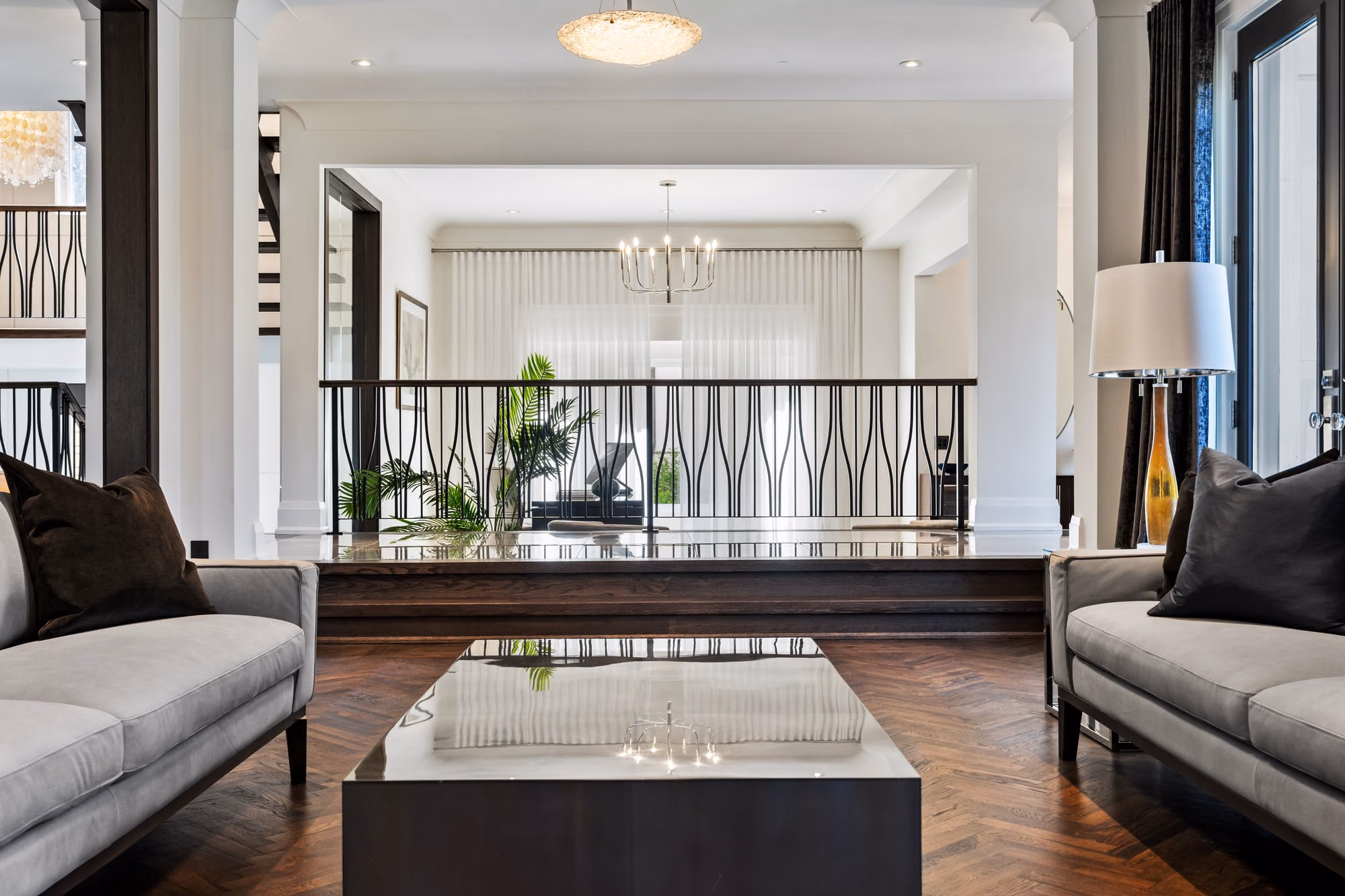 Sunken living room with sectional and glass railing