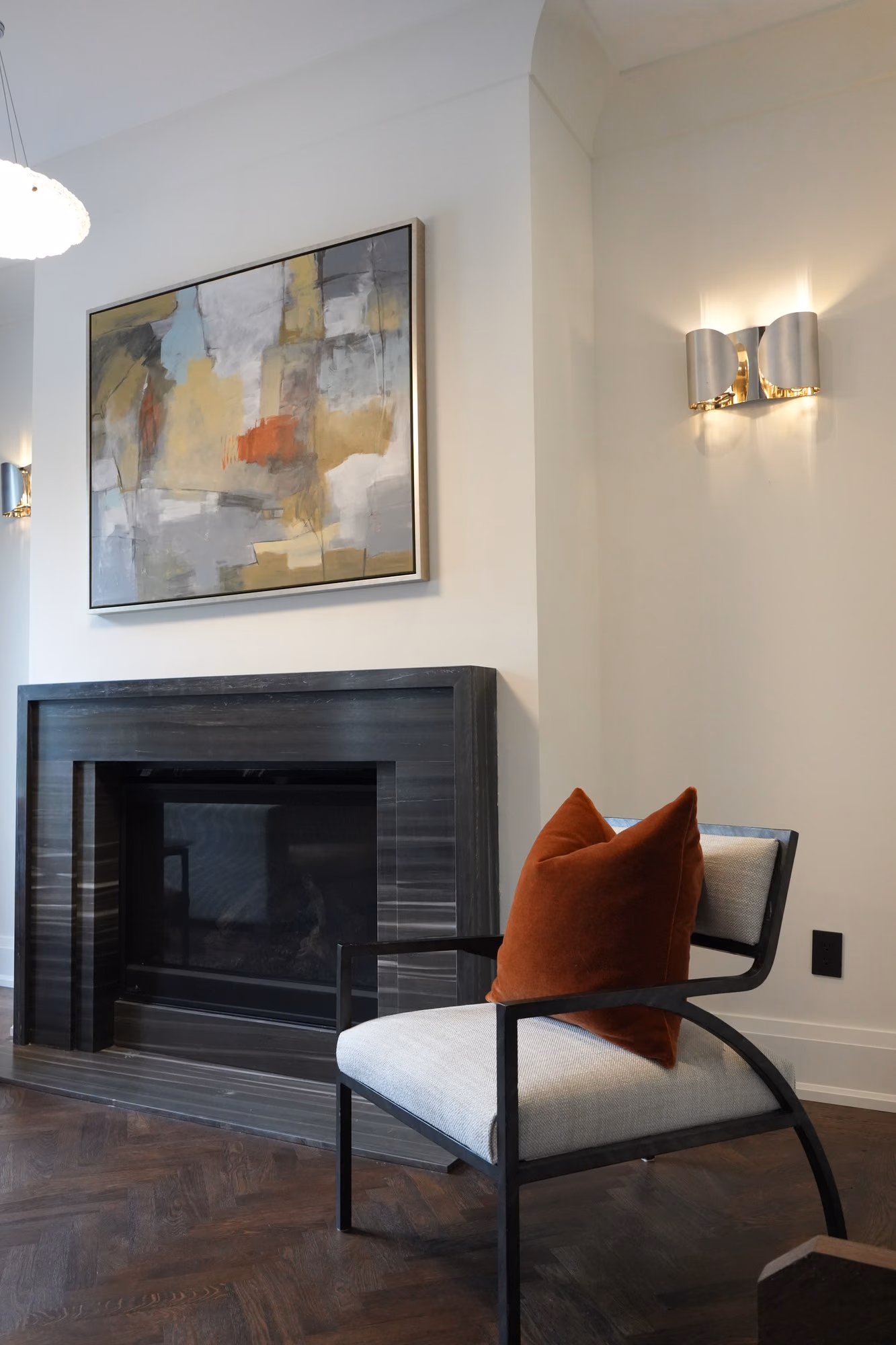 Fireplace with abstract artwork and pendant light