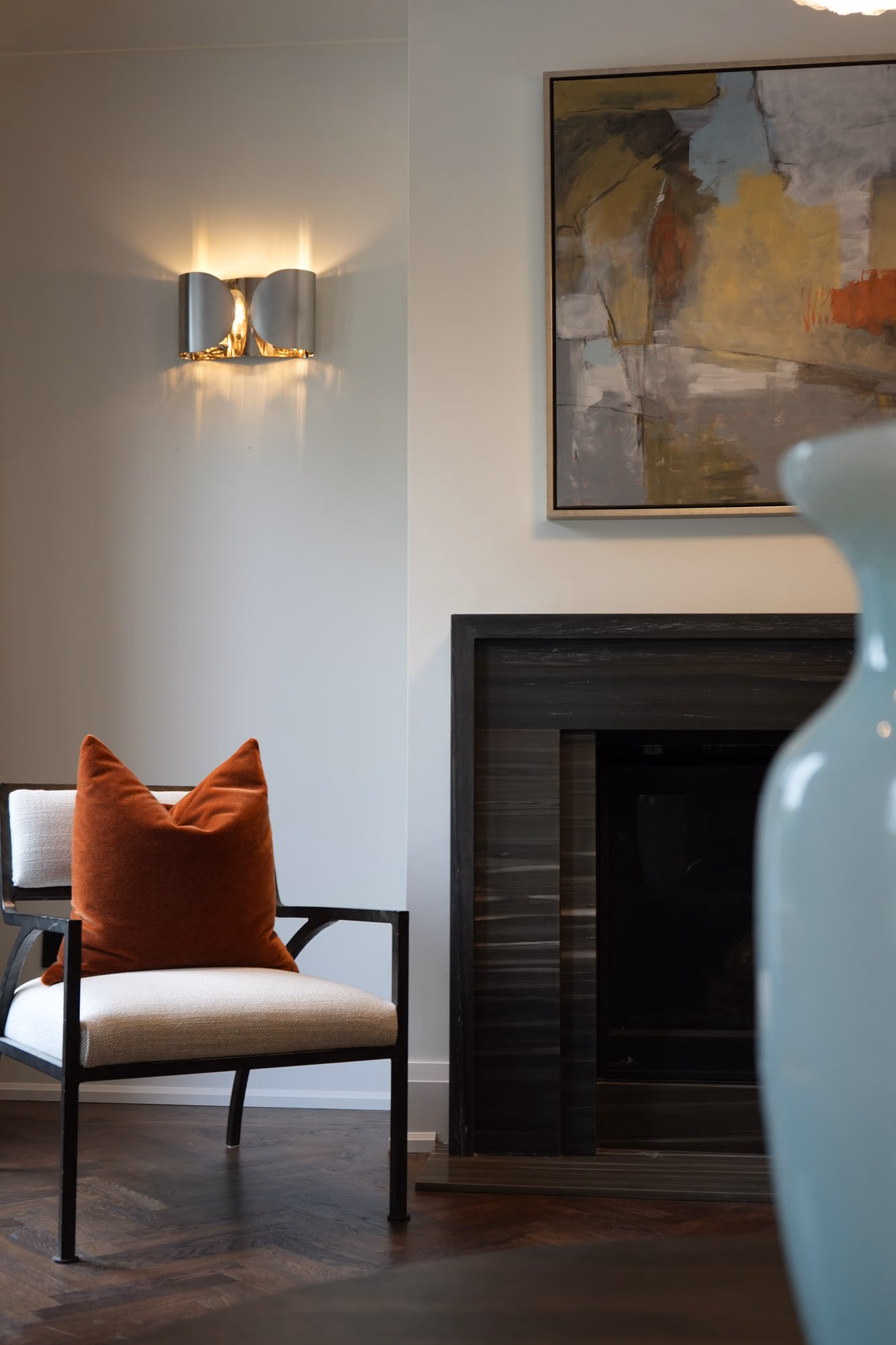 Bedside detail with sconce and orange cushion
