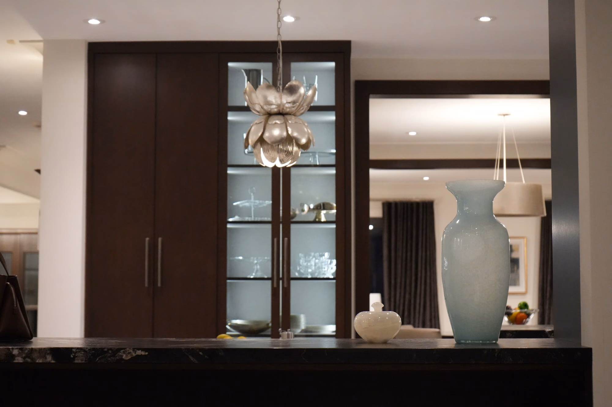 Glass display cabinet with blue vase