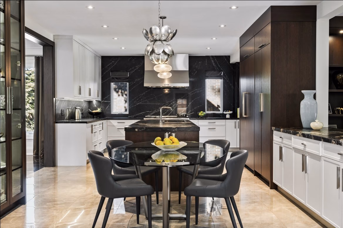 Kitchen and round dining table with dark marble accents
