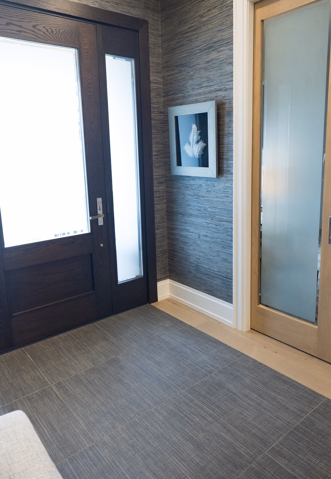Farmhouse entry with dark wood door and frosted glass