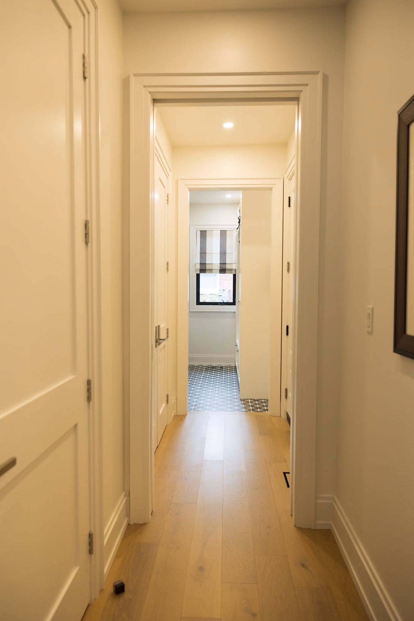 Bright farmhouse hallway with wood floors