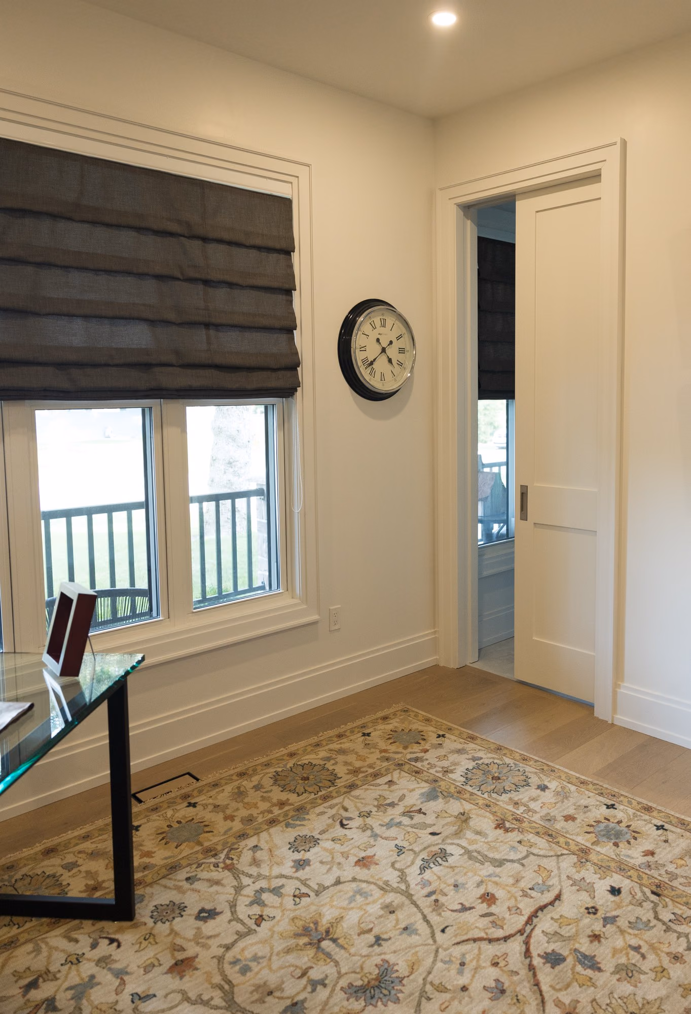 Farmhouse hallway with roman shade and patterned rug