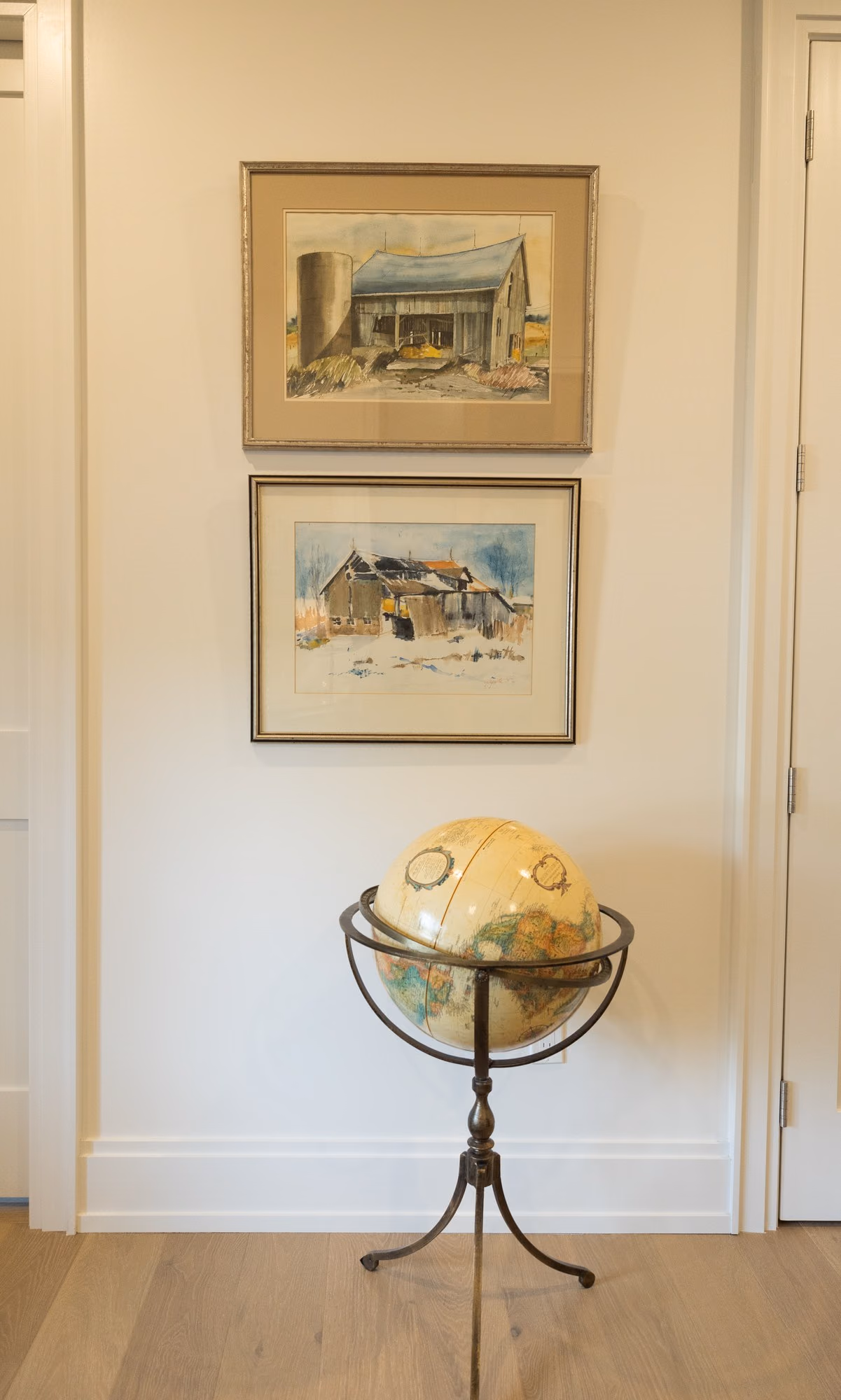 Hallway vignette with globe and watercolors