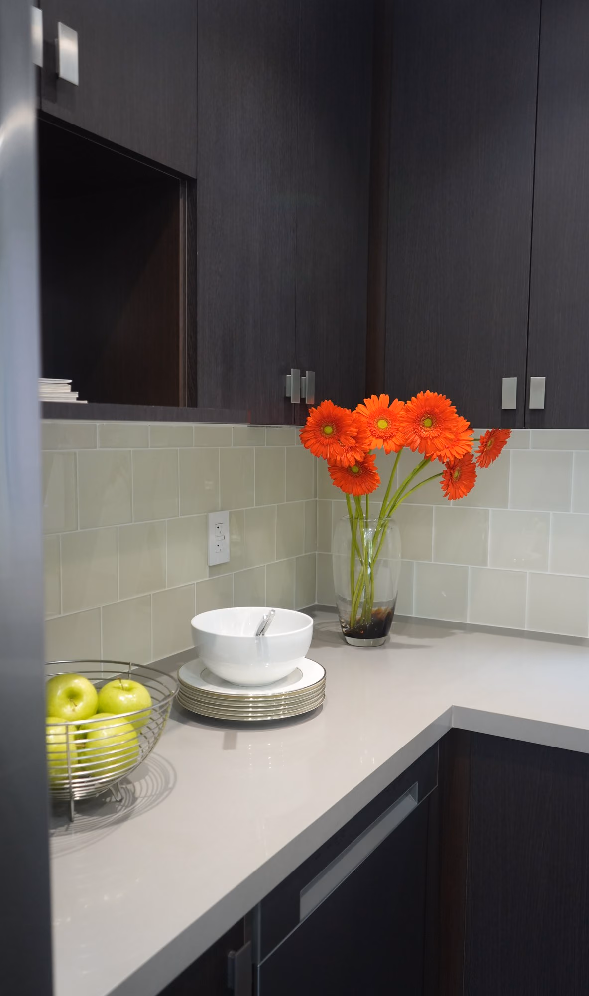 Renovated kitchenette with orange gerbera flowers