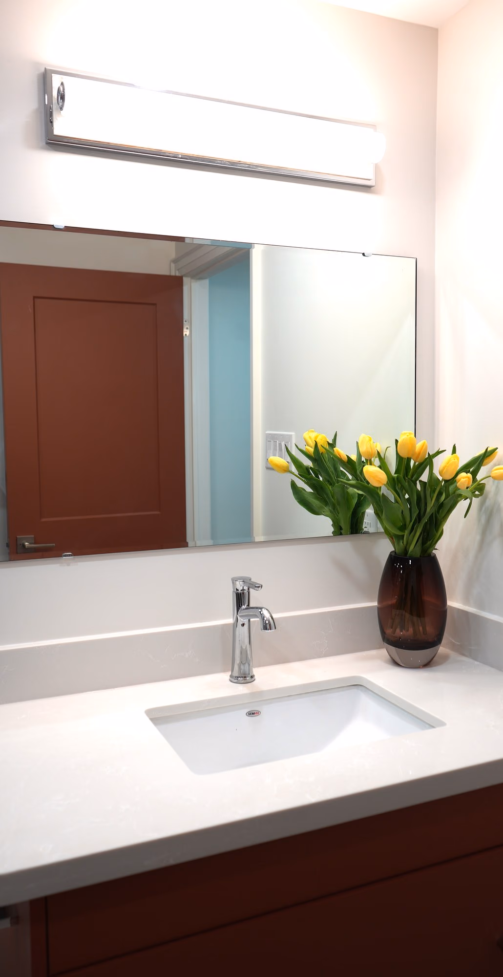Renovated bathroom vanity with tulips and red door