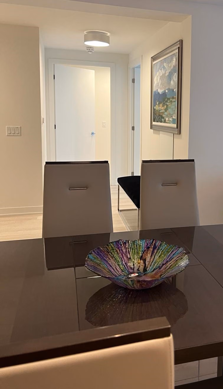 Condo dining table with hallway beyond